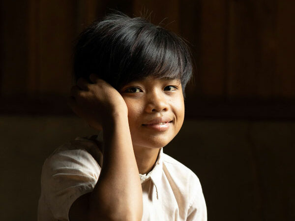 Smiling student in Cambodia supported by UWS education project